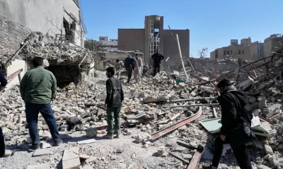 A group of men inspects the ruins of a police station struck Monday amid the US–Israeli military campaign in Tehran, Iran, Tuesday, March 3, 2026.