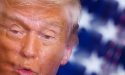 In this image taken with a slow shutter speed, President Donald Trump speaks Thursday during a women's history month event in the East Room of the White House.