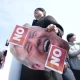 A man holds a picture of U.S. President Donald Trump after a news conference against Trump's demands to multiple countries to send warships to keep the Strait of Hormuz open, near the U.S. Embassy in Seoul, South Korea, on March 16.