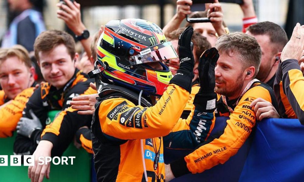 Oscar Piastri gives high fives to his McLaren team members after coming second at Suzuka