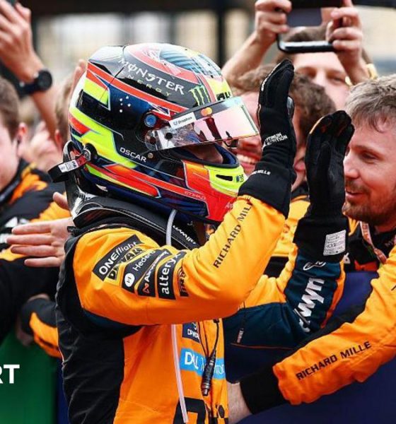 Oscar Piastri gives high fives to his McLaren team members after coming second at Suzuka