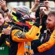 Oscar Piastri gives high fives to his McLaren team members after coming second at Suzuka