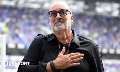 Designer Dan Meis applauds Everton fans at their first home match in their new stadium.