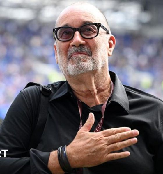 Designer Dan Meis applauds Everton fans at their first home match in their new stadium.