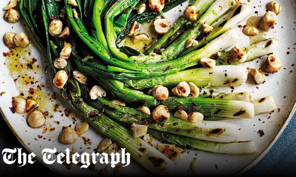 Chargrilled spring onions with hazelnuts and lime and honey dressing