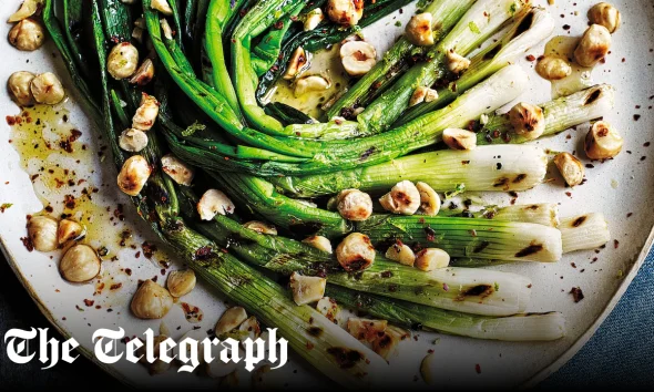 Chargrilled spring onions with hazelnuts and lime and honey dressing