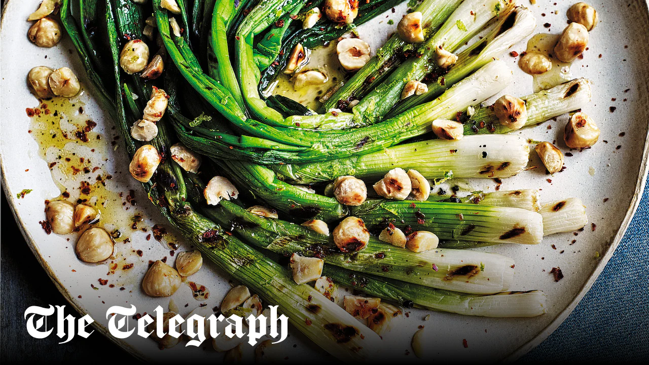Chargrilled spring onions with hazelnuts and lime and honey dressing