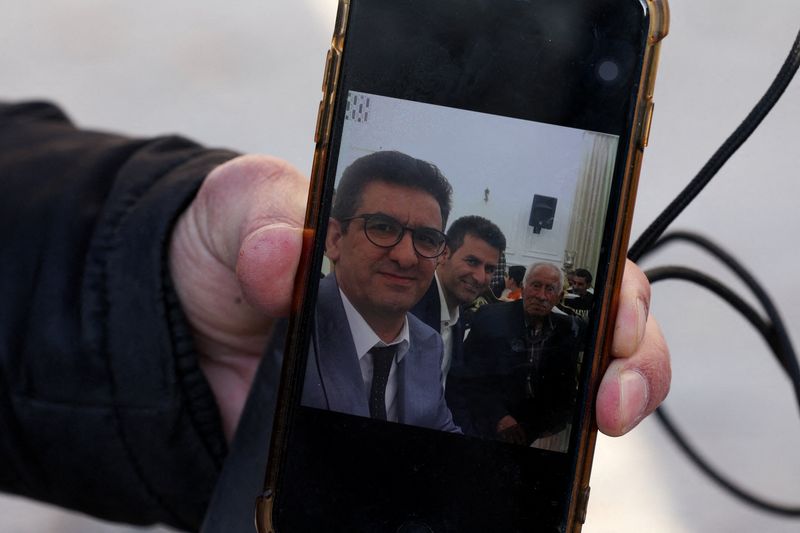 Family of Iranian butcher missing in strike on commercial complex clings to hope