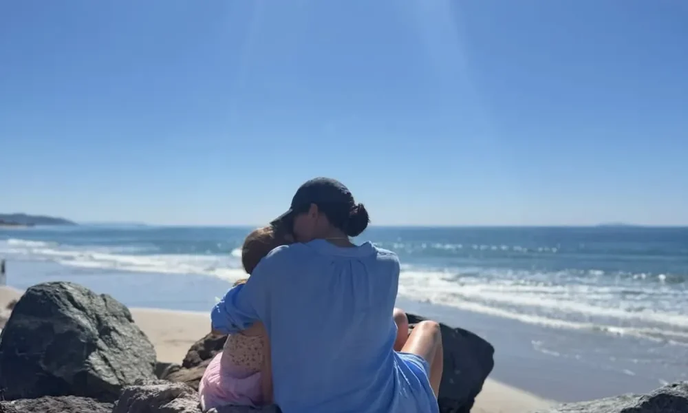 Meghan Markle Kisses Daughter Princess Lilibet, 4, on Beach in Rare Pic Taken by Prince Harry
