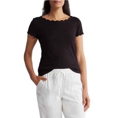 A woman wearing a black scalloped tee and white drawstring pants