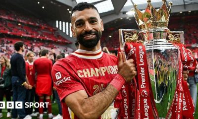 Mohamed Salah poses with the Premier League trophy
