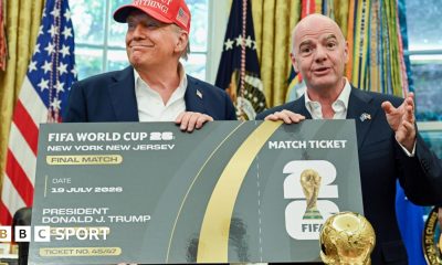 US President Donald Trump and Uefa president Gianni Infantino pose with a giant mock World Cup ticket