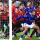 Iliman Ndiaye of Everton holds back Bruno Fernandes and Casemiro of Manchester United as players jostle at a corner kick