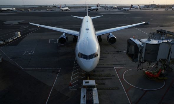 An airplane sits on the tarmac at John F. Kennedy International Airport on the July 4th weekend in Queens, New York City