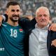 Aymen Hussein (L) raises his fist as he celebrates alongside Iraq head coach Graham Arnold (R) in Basra, Iraq, o