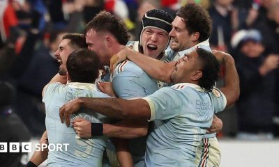 Thomas Ramos is mobbed by his France team-mates after landing the final kick to claim victory