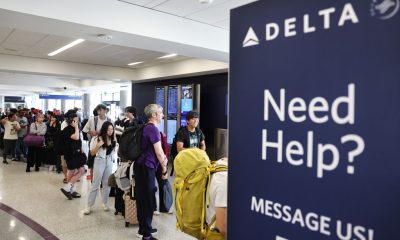 Air travellers wearing protective face masks, amid the coronavirus disease (COVID-19) pandemic, walk at JetBlue Terminal 5 at JFK International airport in New York, U.S., November 16, 2021.