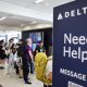 Air travellers wearing protective face masks, amid the coronavirus disease (COVID-19) pandemic, walk at JetBlue Terminal 5 at JFK International airport in New York, U.S., November 16, 2021.
