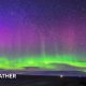 The northern lights shining bright in the night sky with bright green colours in the lower part of the sky and purples higher up