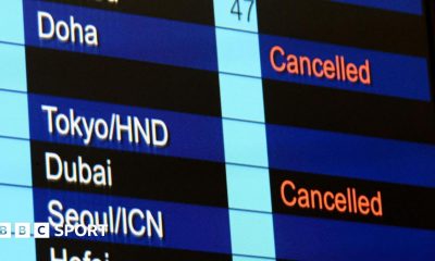 Cancelled flights to Dubai and Doha shown on flight information display at Hong Kong International Airport