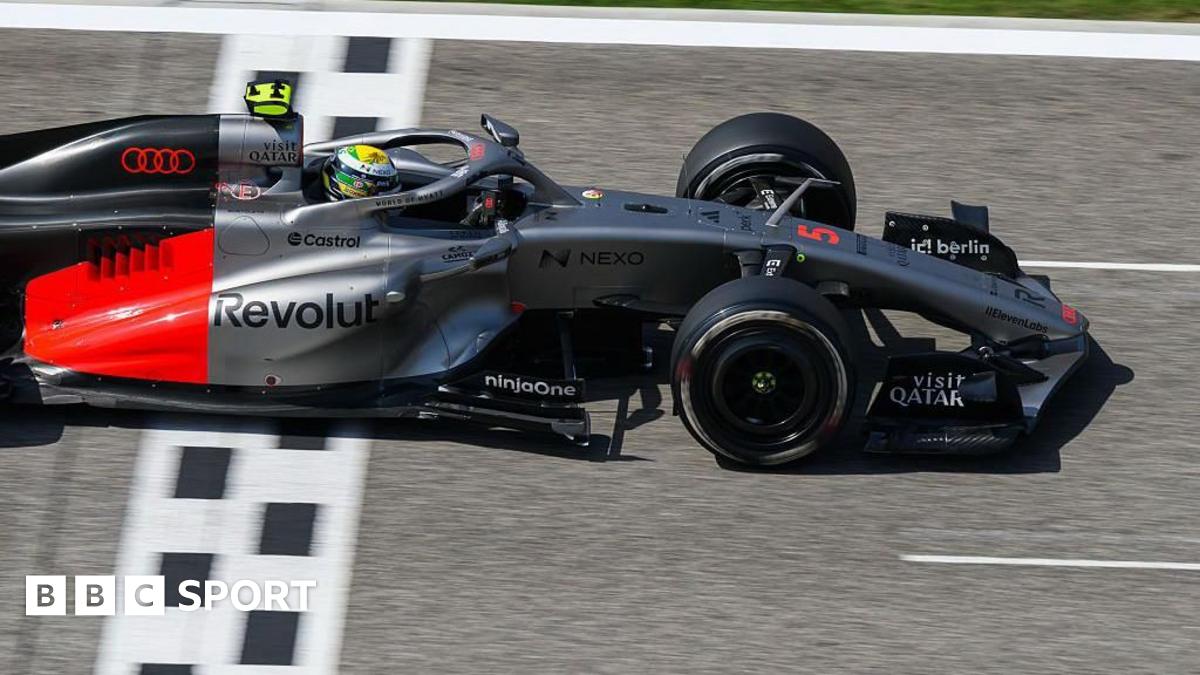 Lewis Hamilton drives the new Ferrari on track in Bahrain, with a McLaren in the background