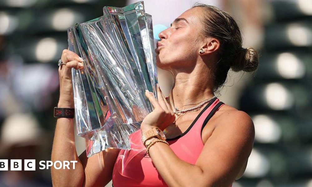 Aryna Sabalenka kisses the Indian Wells trophy