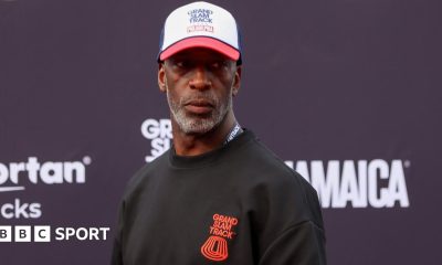 Former athlete Michael Johnson wearing a Grand Slam Track jumper and cap at the league's event in Philadelphia in 2025