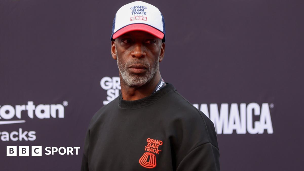Former athlete Michael Johnson wearing a Grand Slam Track jumper and cap at the league's event in Philadelphia in 2025