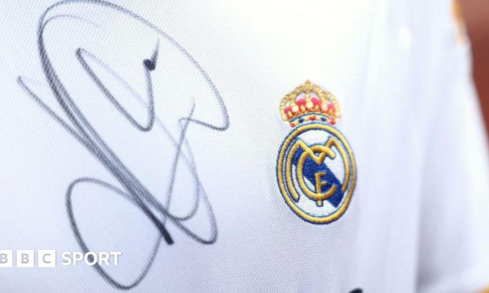A close up image of a Real Madrid shirt signed by Kylian Mbappe