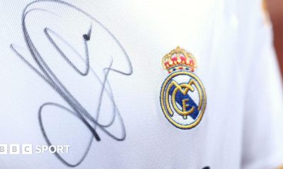 A close up image of a Real Madrid shirt signed by Kylian Mbappe