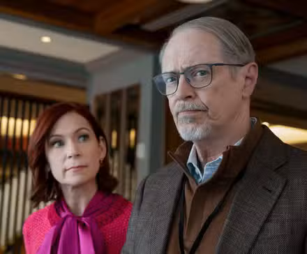 Steve Buscemi glancing with curiosity alongside Carrie Preston in Elsbeth