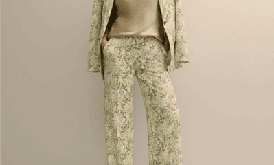 woman wears suit with green floral print