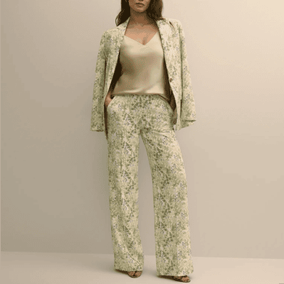 woman wears suit with green floral print
