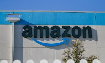 The tech sector led record gains in the S&P 500 index. Pictured: a man with umbrella walks past the New York Stock Exchange.