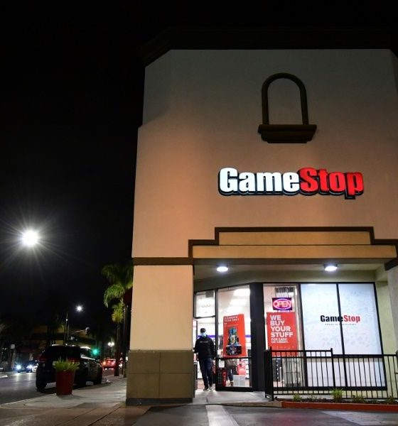 GameStop shares have soared in a clash between a new activist movement and hedge funds
