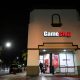 GameStop shares have soared in a clash between a new activist movement and hedge funds