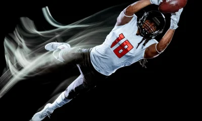 american football player man isolated black background light painting
