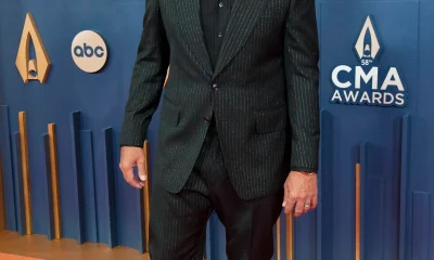 Luke Bryan standing on the CMA red carpet