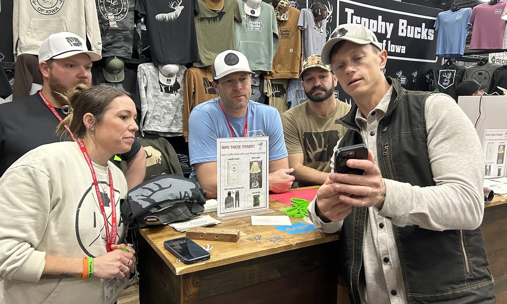 Rob Sand engages with fellow hunters at the Iowa Deer Classic.
