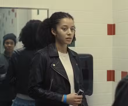 Regina Hall and Chase Infiniti talk in a restroom in One Battle After Another