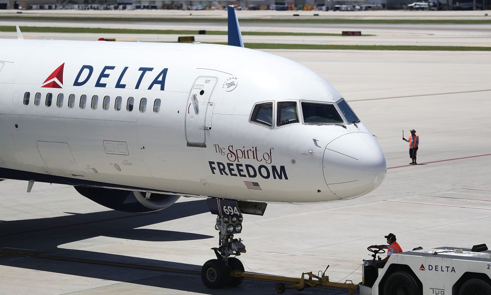 Air travellers wearing protective face masks, amid the coronavirus disease (COVID-19) pandemic, walk at JetBlue Terminal 5 at JFK International airport in New York, U.S., November 16, 2021.