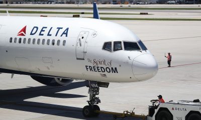 Air travellers wearing protective face masks, amid the coronavirus disease (COVID-19) pandemic, walk at JetBlue Terminal 5 at JFK International airport in New York, U.S., November 16, 2021.