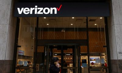 The tech sector led record gains in the S&P 500 index. Pictured: a man with umbrella walks past the New York Stock Exchange.