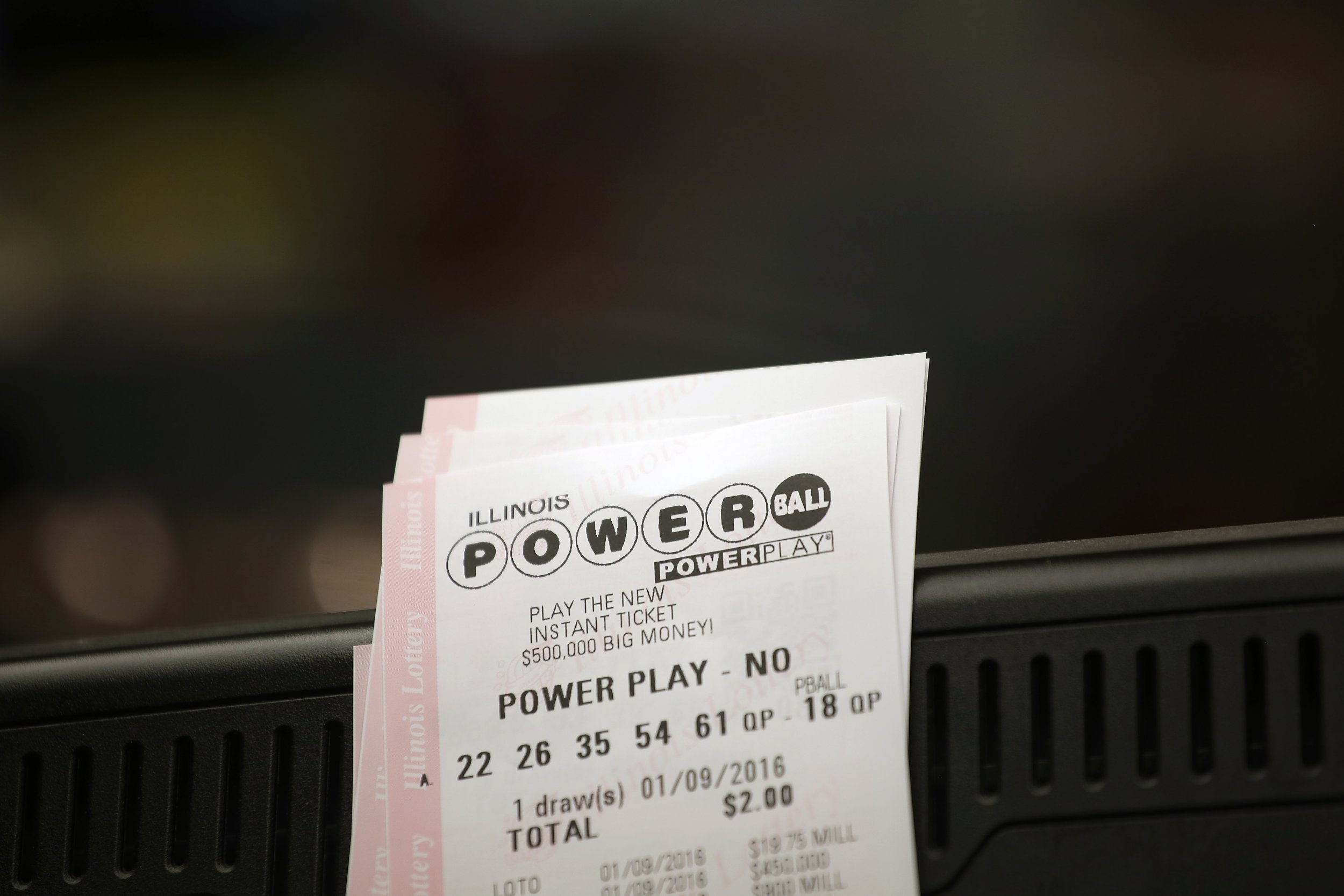 Powerball tickets rest on a 7-Eleven store register January 9, 2016 in Chicago, Illinois.