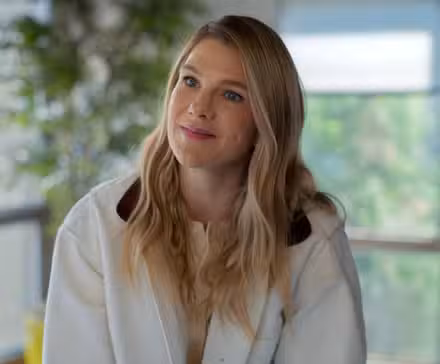 Woman smiling with her head tilted.