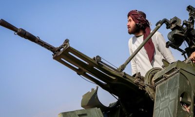 A Taliban fighter stands next to an anti-aircraft gun in Khost province, Afghanistan. Pic: Reuters