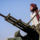 A Taliban fighter stands next to an anti-aircraft gun in Khost province, Afghanistan. Pic: Reuters