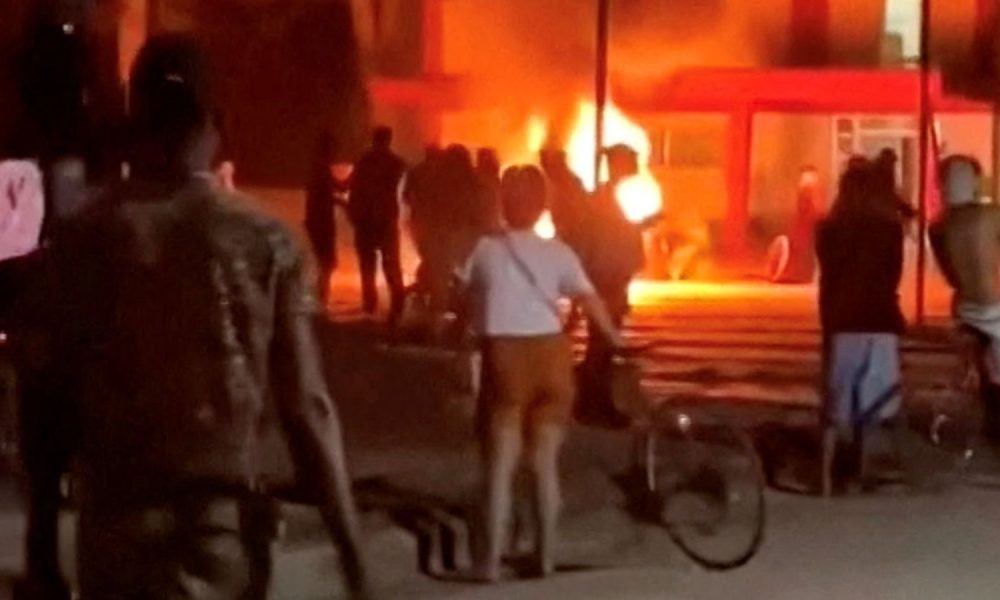 Social media footage of a riot in Cuba showed protesters throwing rocks through windows. Pic: Reuters
