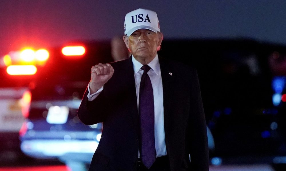 Donald Trump pumps his fist after disembarking Air Force One at Palm Beach International Airport, before the strikes in Iran. Pic: Reuters