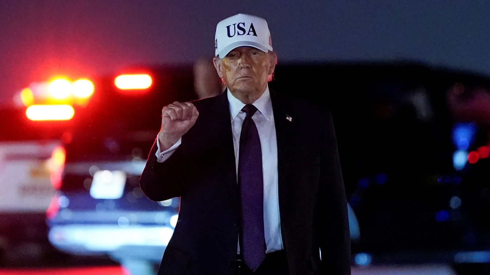 Donald Trump pumps his fist after disembarking Air Force One at Palm Beach International Airport, before the strikes in Iran. Pic: Reuters
